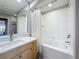 Modern bathroom with a bathtub and shower, featuring a white tile backsplash and modern vanity at 100 4Th S Ave # 312, St Petersburg, FL 33701