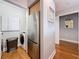 Hallway view showcasing stainless steel refrigerator and laundry area at 100 4Th S Ave # 312, St Petersburg, FL 33701