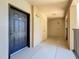 Hallway with door to unit 317, storage closet, and exit sign at 100 4Th S Ave # 312, St Petersburg, FL 33701