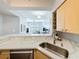 Bright kitchen features a sink, marble countertop, wine rack and connection to the living area at 100 4Th S Ave # 312, St Petersburg, FL 33701