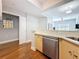 Modern kitchen with stainless steel appliances, light wood cabinets, and a view into the living room at 100 4Th S Ave # 312, St Petersburg, FL 33701