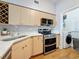 Well-equipped kitchen with stainless steel appliances, quartz countertops, and a washer and dryer at 100 4Th S Ave # 312, St Petersburg, FL 33701