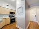 Stylish kitchen featuring light wood cabinets and stainless steel appliances with dark hardwood floors at 100 4Th S Ave # 312, St Petersburg, FL 33701