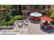 An outdoor lounge area with chaise lounges and tables near the community pool with landscaping at 100 4Th S Ave # 312, St Petersburg, FL 33701