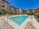 Community pool with marked depth surrounded by lounge seating and mature landscaping at 100 4Th S Ave # 312, St Petersburg, FL 33701