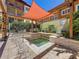 Inviting community spa with overhead shade, stone accents, and verdant landscaping at 100 4Th S Ave # 312, St Petersburg, FL 33701