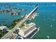Aerial view of complex, bridge, and bay surrounded by lush neighborhoods with waterfront access at 100 Bluff View Dr # 308A, Belleair Bluffs, FL 33770