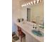 Bathroom with white vanity and basin sink, large mirror, and decorative accents at 100 Bluff View Dr # 308A, Belleair Bluffs, FL 33770