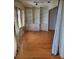 Living room featuring hardwood floors, large windows, and built-in shelving at 100 Bluff View Dr # 308A, Belleair Bluffs, FL 33770