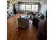 Bright living room with hardwood floors, modern furniture, and a large window overlooking the water at 100 Bluff View Dr # 308A, Belleair Bluffs, FL 33770