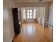 View of living room with hardwood floors, built-in shelving, and a large window at 100 Bluff View Dr # 308A, Belleair Bluffs, FL 33770