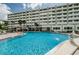 Large community pool with lounging area at 100 Bluff View Dr # 308A, Belleair Bluffs, FL 33770