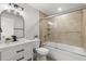 Bright bathroom with a vanity, bathtub, and a sliding glass door to the shower at 109 13Th St, Belleair Beach, FL 33786