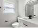 Modern half bathroom with new vanity, a sleek toilet, and a minimalist design at 109 13Th St, Belleair Beach, FL 33786