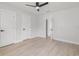 Bright bedroom features neutral tones, wood-look flooring, and a ceiling fan at 109 13Th St, Belleair Beach, FL 33786