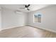Bright bedroom with wood-look tile floors, a ceiling fan, and a window offering natural light at 109 13Th St, Belleair Beach, FL 33786