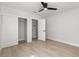 Bedroom featuring wood-look tile floors, with an open closet and doorway at 109 13Th St, Belleair Beach, FL 33786