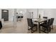 Bright dining area with open access to the kitchen, featuring a modern dining set at 109 13Th St, Belleair Beach, FL 33786