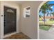 Inviting entryway showcasing an arched doorway and a decorative glass front door at 109 13Th St, Belleair Beach, FL 33786
