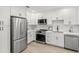 Updated kitchen boasts stainless steel appliances, white shaker cabinets and quartz countertops at 109 13Th St, Belleair Beach, FL 33786
