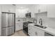 Updated kitchen features stainless steel appliances, white shaker cabinets, and modern fixtures at 109 13Th St, Belleair Beach, FL 33786