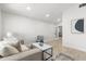 Cozy living area featuring a comfortable sofa, modern decor, and neutral color palette at 109 13Th St, Belleair Beach, FL 33786