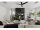 Bright living room with black fireplace, plush sofa, and stylish decor at 109 13Th St, Belleair Beach, FL 33786