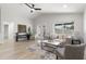 Bright and airy living room featuring a vaulted ceiling, a comfortable sofa, and large windows at 109 13Th St, Belleair Beach, FL 33786