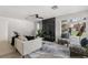 Cozy living room with sleek fireplace, comfortable sofa, and ample natural light at 109 13Th St, Belleair Beach, FL 33786