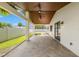 Spacious covered patio with views of the landscaped backyard and in-ground pool at 109 13Th St, Belleair Beach, FL 33786