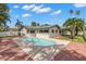 Exterior view of a private in-ground pool, surrounded by tropical landscaping at 109 13Th St, Belleair Beach, FL 33786