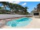 Beautiful in-ground pool is surrounded by lush tropical landscaping and fencing at 109 13Th St, Belleair Beach, FL 33786