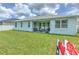 Back exterior view of home with manicured lawn, covered patio area, and outdoor seating at 11336 Callaway Pond Dr, Riverview, FL 33579