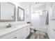 Stylish bathroom featuring a double sink vanity, framed mirrors, updated lighting, and a shower-tub combo at 11336 Callaway Pond Dr, Riverview, FL 33579