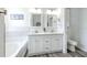 This bathroom showcases a dual sink vanity with a separate tub and toilet at 11336 Callaway Pond Dr, Riverview, FL 33579