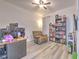 Comfortable bedroom with hardwood flooring, ample natural light, and a view to a nice bookcase at 11336 Callaway Pond Dr, Riverview, FL 33579