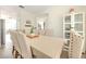 Well-lit dining room features neutral colors, a table set for six, and a contemporary display cabinet at 11336 Callaway Pond Dr, Riverview, FL 33579
