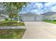 Charming single-story home featuring a three-car garage, manicured lawn, and a welcoming entryway at 11336 Callaway Pond Dr, Riverview, FL 33579