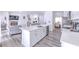 Modern kitchen with stainless steel appliances, quartz countertops, a central island, and an open layout at 11336 Callaway Pond Dr, Riverview, FL 33579
