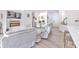 Spacious living area with gray sofas, workstation, and an electric fireplace creates a cozy, modern ambiance at 11336 Callaway Pond Dr, Riverview, FL 33579