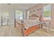 This is a bedroom featuring wood floors and a decorative wall with a decorative bed at 11336 Callaway Pond Dr, Riverview, FL 33579