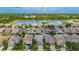 Aerial view of a neighborhood showcasing well-maintained homes, lush landscaping, and a beautiful lake at 12121 Tree Haven Ave, Gibsonton, FL 33534