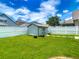 Backyard featuring green grass, a shed, and a white vinyl privacy fence at 12121 Tree Haven Ave, Gibsonton, FL 33534