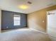 Bedroom featuring a large window, neutral carpet, and a two-tone paint scheme at 12121 Tree Haven Ave, Gibsonton, FL 33534