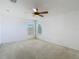 Bright bedroom featuring neutral carpet, ceiling fan, and natural light coming through two windows at 12121 Tree Haven Ave, Gibsonton, FL 33534