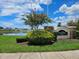 Community sign for SouthBay Lakes with a beautiful flowering tree on a sunny day at 12121 Tree Haven Ave, Gibsonton, FL 33534