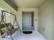 Inviting covered front porch featuring seating area, and a decorative front door at 12121 Tree Haven Ave, Gibsonton, FL 33534