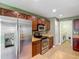 Updated kitchen with stainless appliances, ample cabinet space, and tile flooring at 12121 Tree Haven Ave, Gibsonton, FL 33534