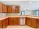 Kitchen area with stainless steel appliances and a sink overlooking the backyard at 12121 Tree Haven Ave, Gibsonton, FL 33534
