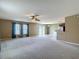 Spacious living room featuring neutral paint, large windows, and adjacent kitchen at 12121 Tree Haven Ave, Gibsonton, FL 33534